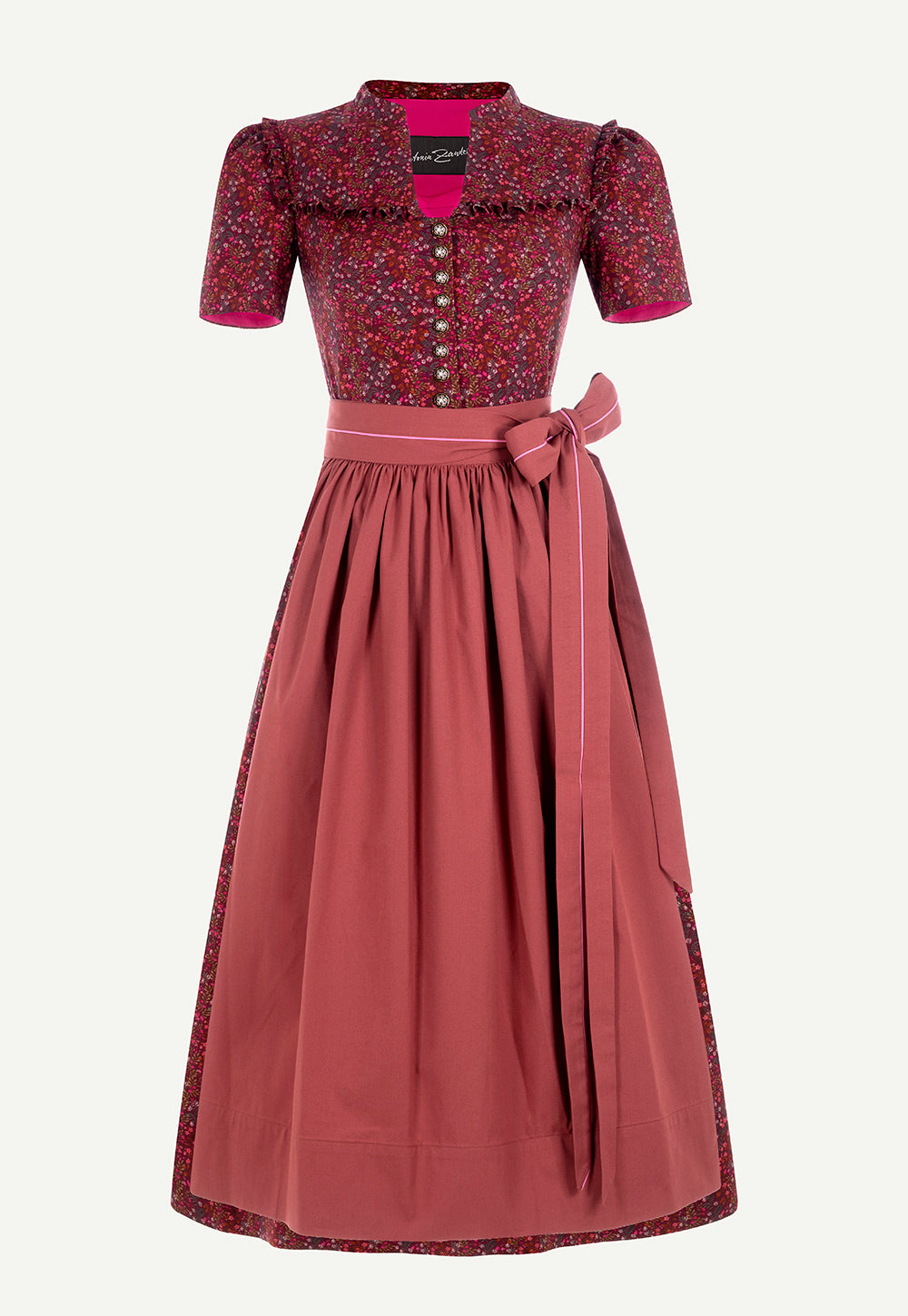 Antonia Zander Alexa Dirndl in Pinto Red with a floral print, dusty rose apron, ruffle details and decorative buttons.