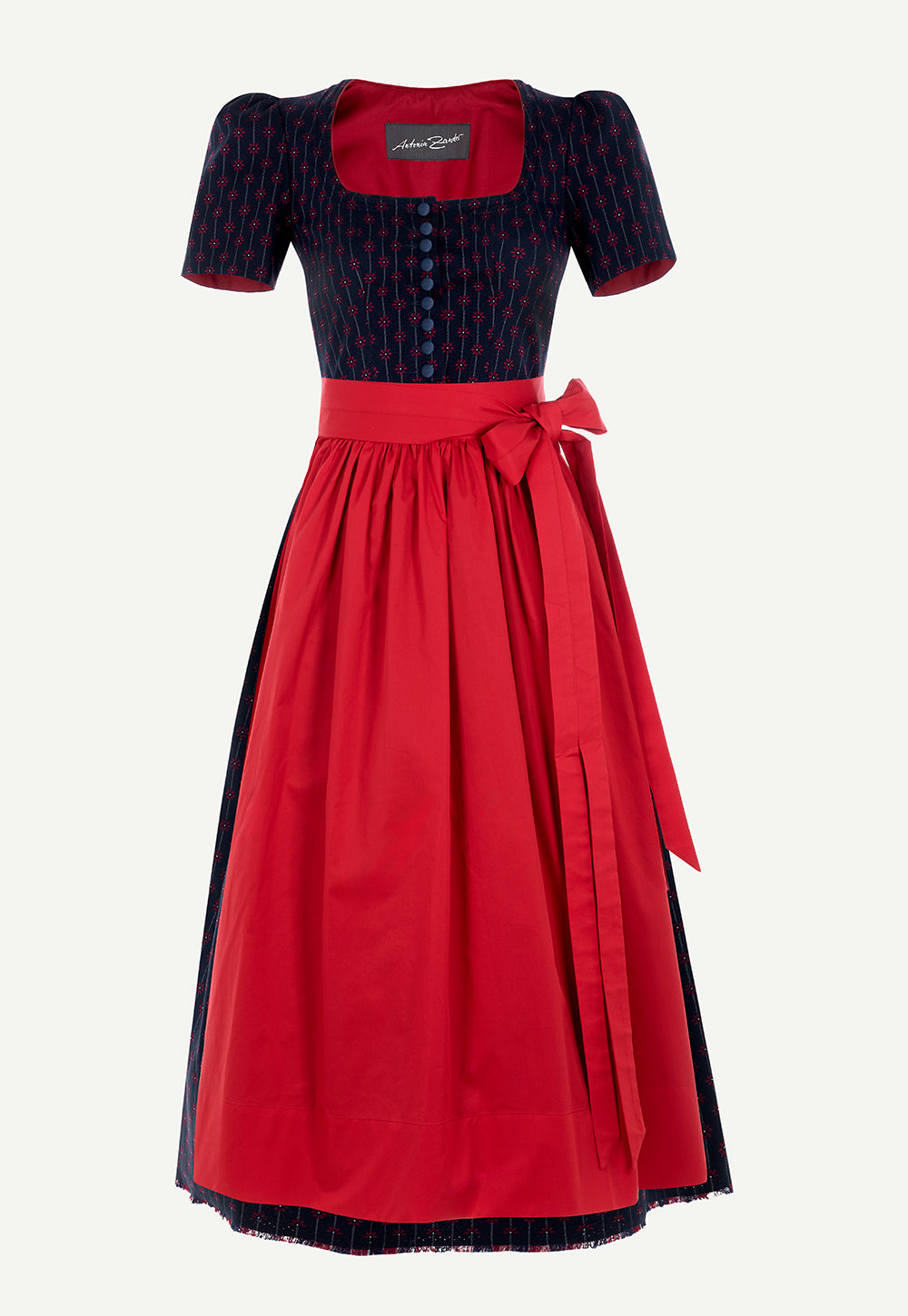 Antonia Zander Judith Dirndl in Flower Navy Red with a navy floral pattern, vibrant red apron and decorative fabric-covered buttons.