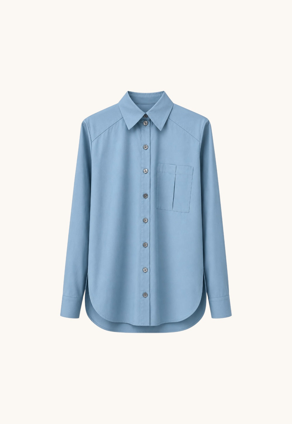 Blue Safira blouse in crisp cotton with oversized chest pocket and tonal mother-of-pearl buttons by Antonia Zander.